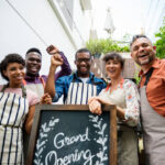 Diverse People with Grand Opening Sign First Day of Business