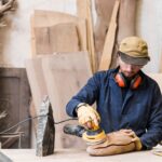 man-sanding-wood-with-orbital-sander-workshop_23-2147944821